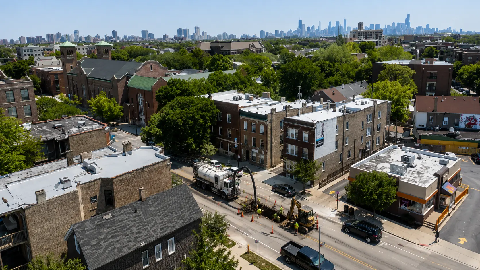 Aerial view of a North Side Chicago neighborhood with active sewer repair work taking place along a residential street.