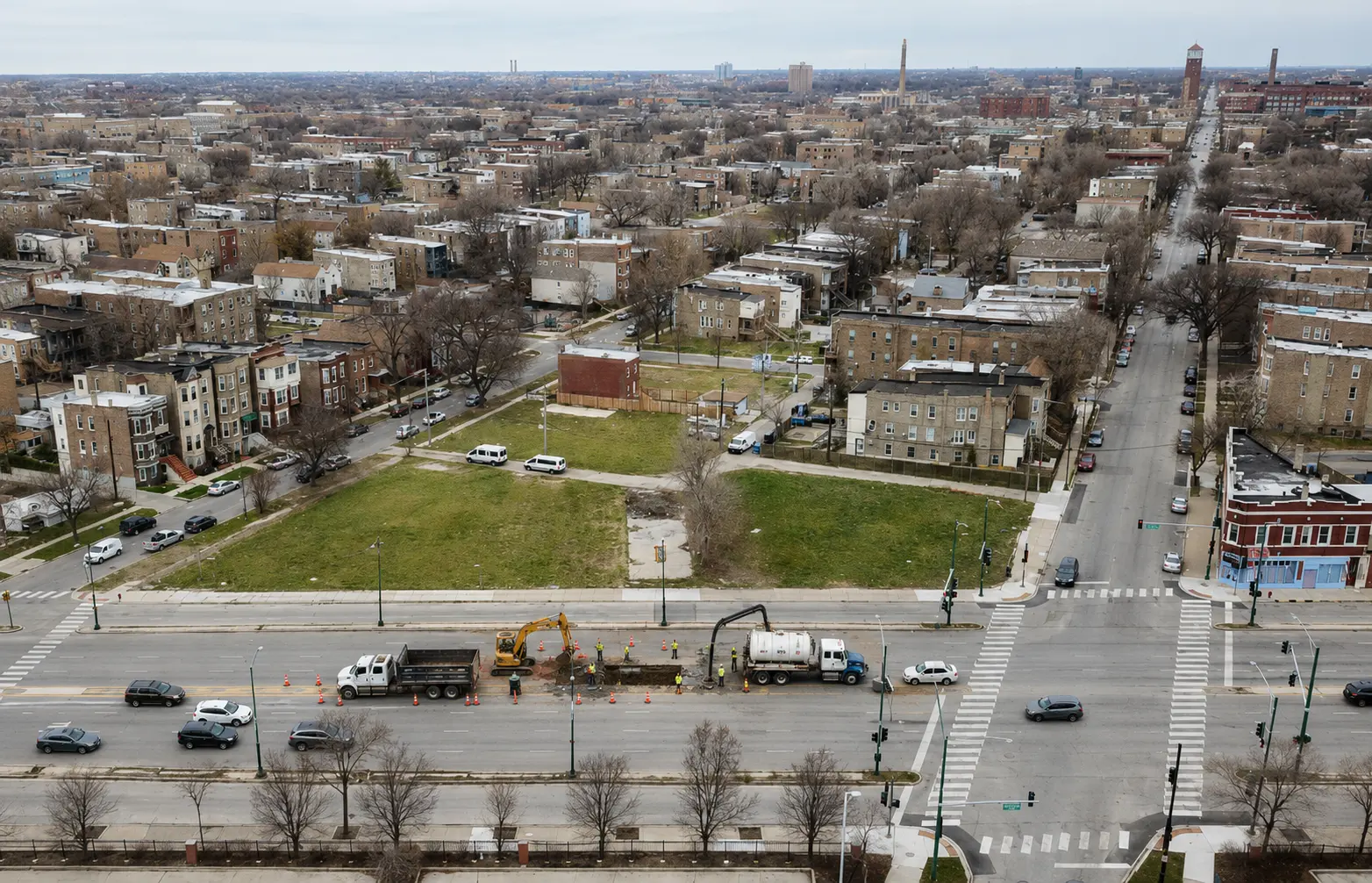 Aerial view of a West Side Chicago neighborhood with active sewer repair work underway along a major residential corridor.